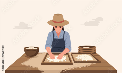 A woman preparing rice paper by spreading batter onto square frames