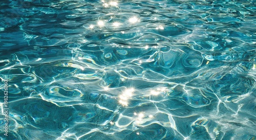 Sunlight dances on the surface of clear, turquoise water creating a shimmering, ethereal effect.