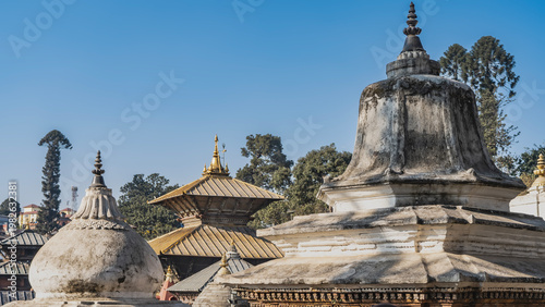Ancient Newar architecture. Pashupatinath Temple.  Domes of funerary temples against the blue sky. Nepal. Kathmandu.