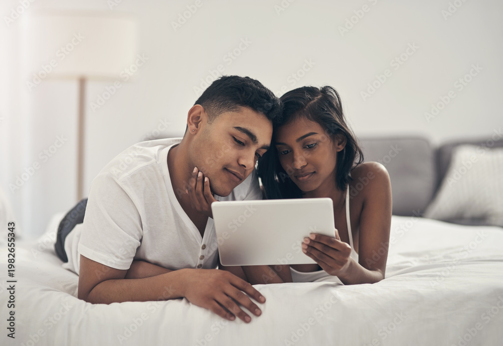 Fototapeta premium Love, relax and tablet with couple in bedroom of home together for bonding or break. App, comfortable and relationship with people on bed in apartment for morning, weekend streaming or wellness