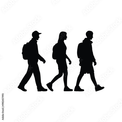 Three silhouetted people walking together in a line outdoors