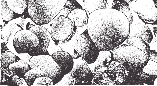 Close up of textured grey pebbles and stones with stippled effect pattern