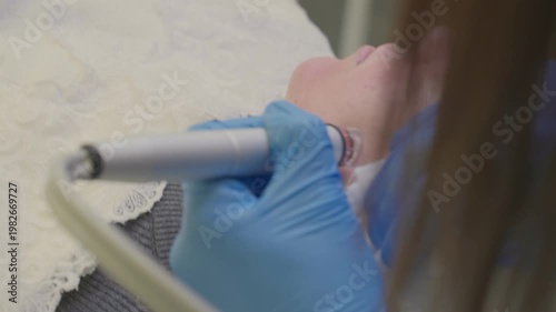 A woman gets a vacuum facial cleansing in a cosmetology room. Cleansing the skin.