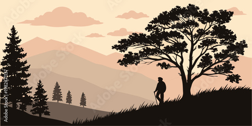 Hiker standing on a grassy hill under a large tree looking at mountain range landscape with mountain landscape silhouette adventure climbing trekking wilderness solitude twilight