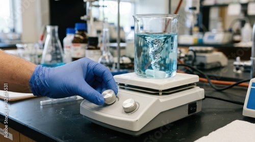 Scientist adjusting the speed of a magnetic stirrer in a laboratory