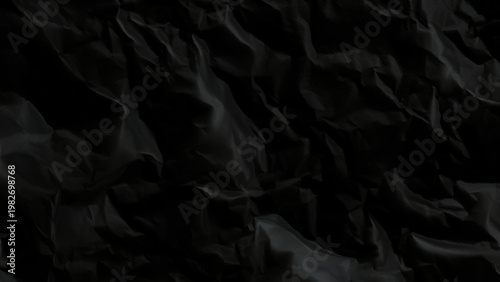 Crumpled black paper texture background with wrinkled folds and creases