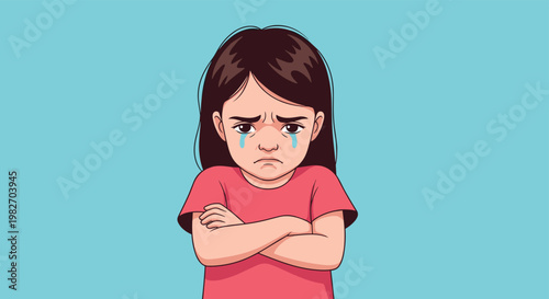 Upset young girl with long dark hair stands with her arms crossed and tears in her eyes on a plain blue background.