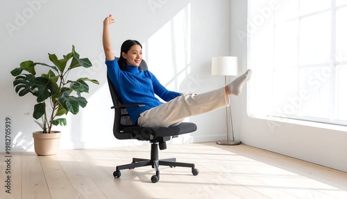 A woman sits on an office chair with one arm raised
