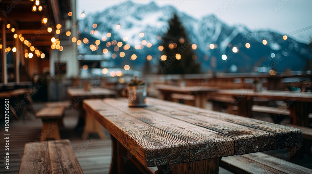 Obraz premium Cozy Mountain Terrace Scene With Tables And Blurred Alpine Landscape