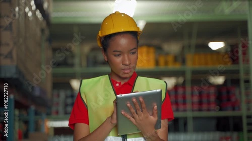 Close-up of warehouse employee using tablet device for digital inventory management inside industrial storage environment

