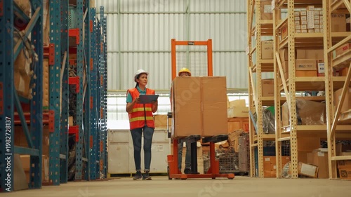 Warehouse worker directing forklift operator carrying boxes in industrial storage facility, emphasizing teamwork and logistics operations
