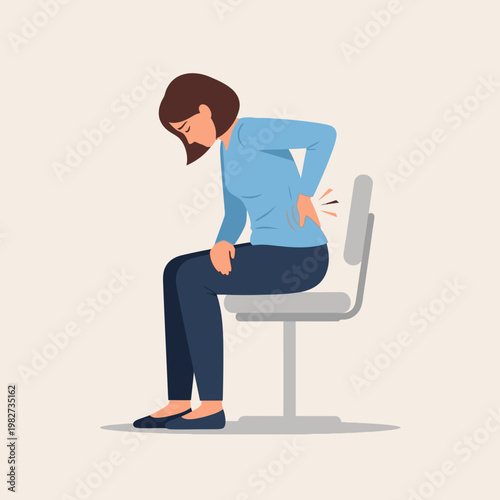Woman sitting on chair with back pain, holding her lower back, discomfort and ache