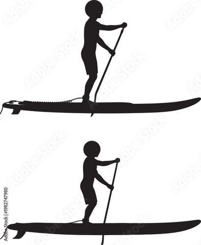 Silhouettes of a person stand up paddle boarding