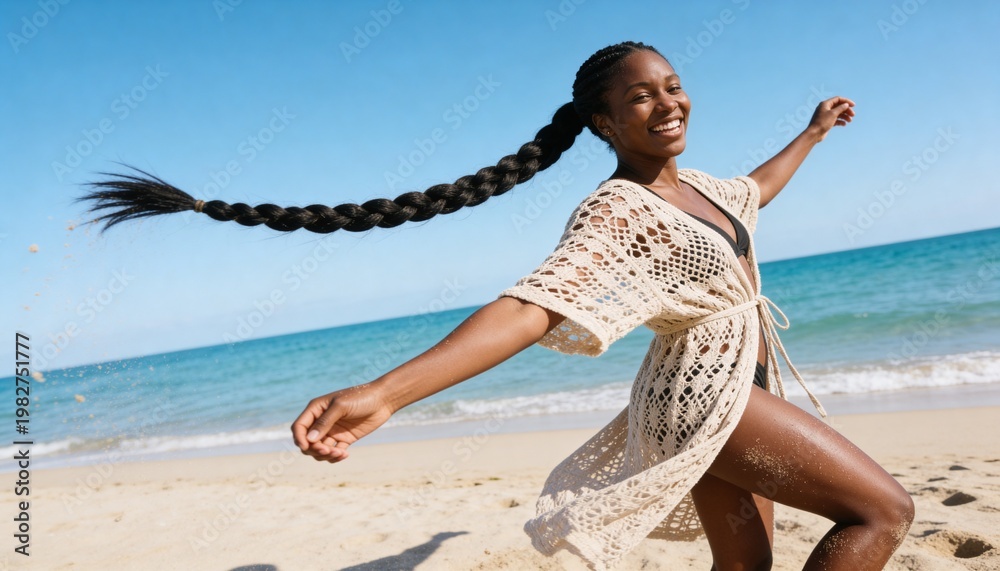 Fototapeta premium Happy young Black woman with a long braid smiling on the beach. Joyful person enjoying a summer vacation by the ocean. Skincare and wellness concept