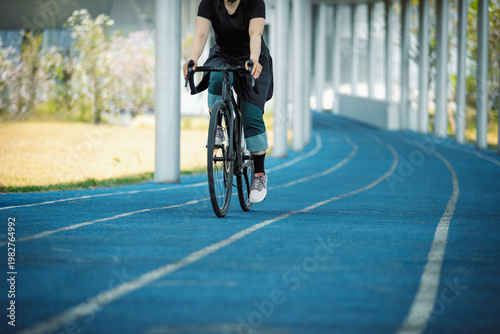 Photography Woman riding road bike at the outdoor stadium