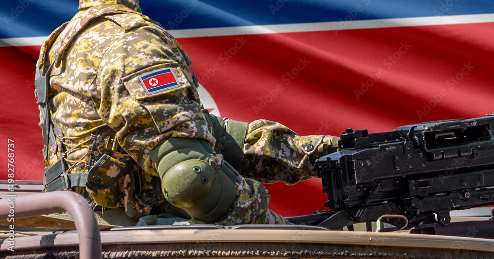 Obraz premium North Korea flag with soldier at machinegun turret