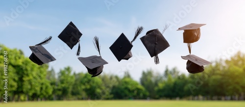 Graduating class in caps throwing their hats into the air celebrating achievement