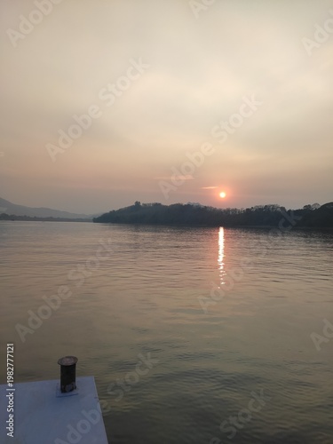 Traditional River Boat with Lao Flag and Mountain Landscape