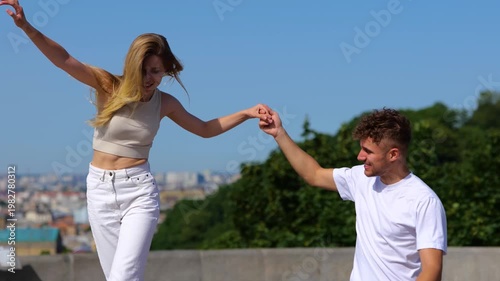 Romantic couple walking in the city. Happy beautiful young woman and handsome man having fun outdoors. Bonding, love and relationship concept. Real time