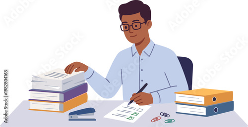 A man sits at a desk studying with books and writing on paper