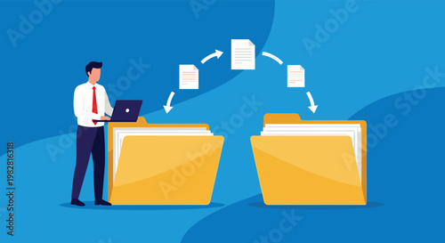 Productive office employee using a laptop to transfer digital files and documents between two yellow storage folders.