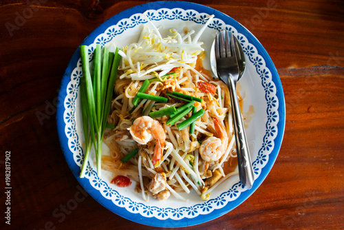 Traditional thai street food Pad Thai or Padthai cuisine meal thai style stir fried rice noodles with egg and vegetable mix spices sauce and shrimp at local restaurant cafe shop in Bangkok, Thailand