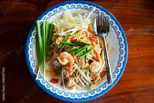 Obraz Traditional thai street food Pad Thai or Padthai cuisine meal thai style stir fried rice noodles with egg and vegetable mix spices sauce and shrimp at local restaurant cafe shop in Bangkok, Thailand