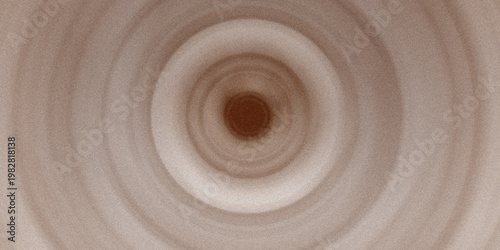 Abstract brown circular ripple pattern with textured grain effect