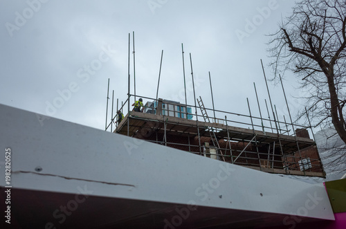 Construction site with workers on scaffolding
