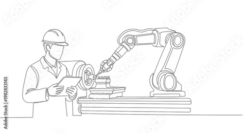 A worker operates industrial robotic arm.