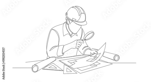 A construction worker studying architectural blueprints.