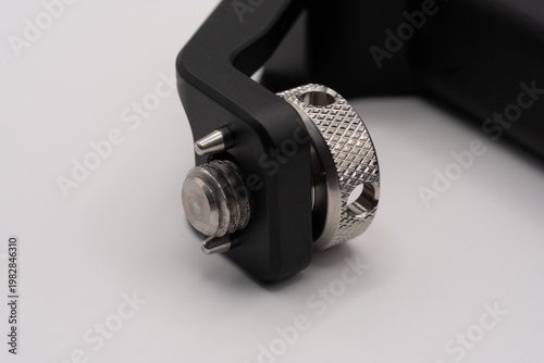 Close-up of metallic screw and black clamp mechanism