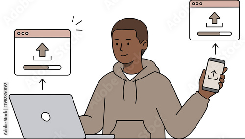 A man sitting at a desk is uploading files from his laptop to his phone.