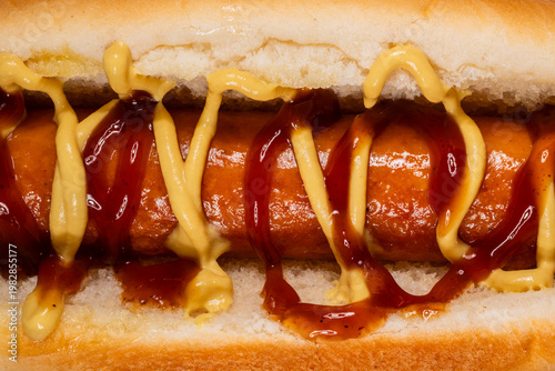 Tasty hot dog with mustard and ketchup in macro shot