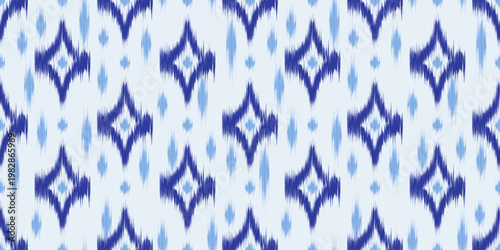 Ikat ethnic seamless pattern with abstract print. Vector ornamental background with rug texture. Retro blue rhombus decoration with dye effect