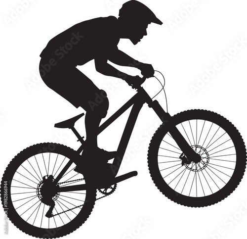 Mountain bike rider silhouette performing downhill stunt with full face helmet on mountain bicycle