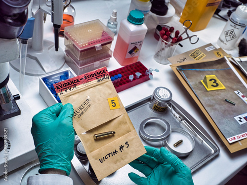 A police ballistics expert examines a bullet recovered from a homicide scene, conceptual image