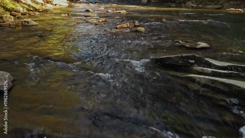 Rapid Water Over Rocky Riverbed Details. Brisk Water Rushing Through Textured Bed In Czech Landscapes