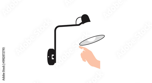 A single human hand reaches up to pull the thin white switch cord of a stylish black and white adjustable wall lamp against a plain white background.