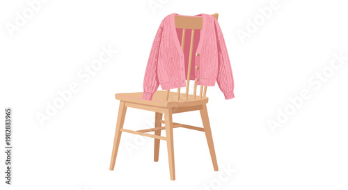 A delicate pink knitted cardigan with elegant gold buttons hangs gracefully over the back of a classic light-colored wooden spindle chair against white.