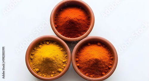Assortment of colorful spices in oval dishes on a white surface