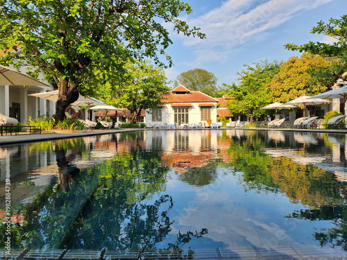 Tropical Resort Swimming Pool with Reflection and Blue Sky
