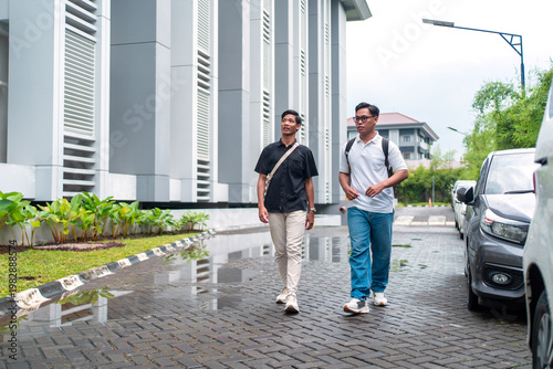 Two Asian Indonesian Men Walking Near Parking Area After Rain