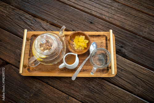 A set of herbal drinks with lemongrass, tea, ginger, honey and various rhizomes, on an old wooden table