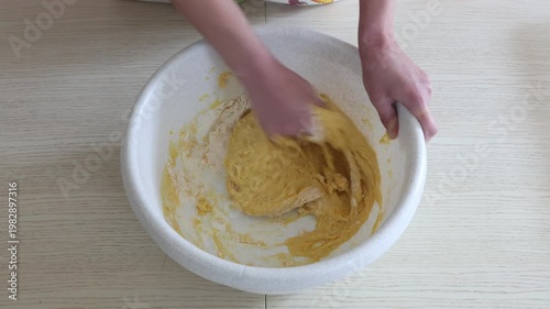 Female baker kneading dough for homemade bread preparation