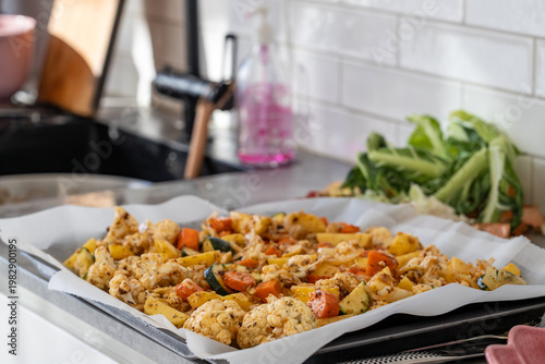 Stockholm, Sweden  Raw marinated potatoes and cauliflower on a baking pan for roasting.