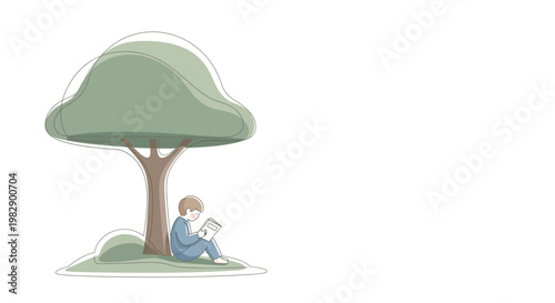 Boy sitting under a tree reading.
