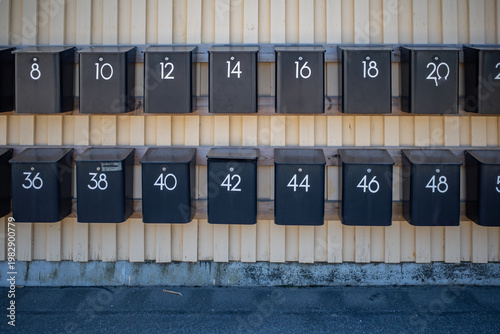 Akersberga, Sweden Numbered mailboxes in a residential parking lot.