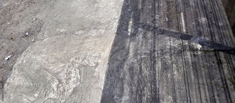 Fototapeta premium Gritty Concrete Road Surface With Sharp Shadow