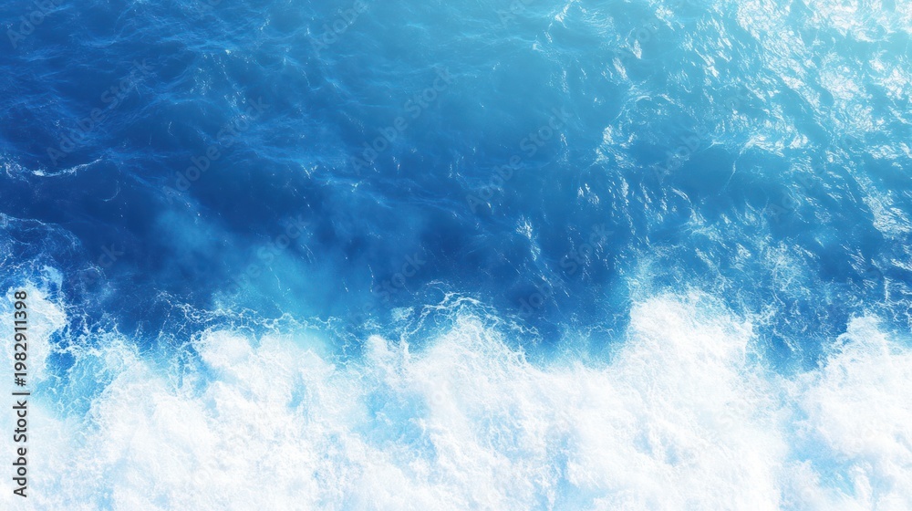 Obraz premium Azure Majesty: A mesmerizing aerial view unveils the dance of ocean waves in a symphony of blues and whites, as they churn and crash with untamed power.